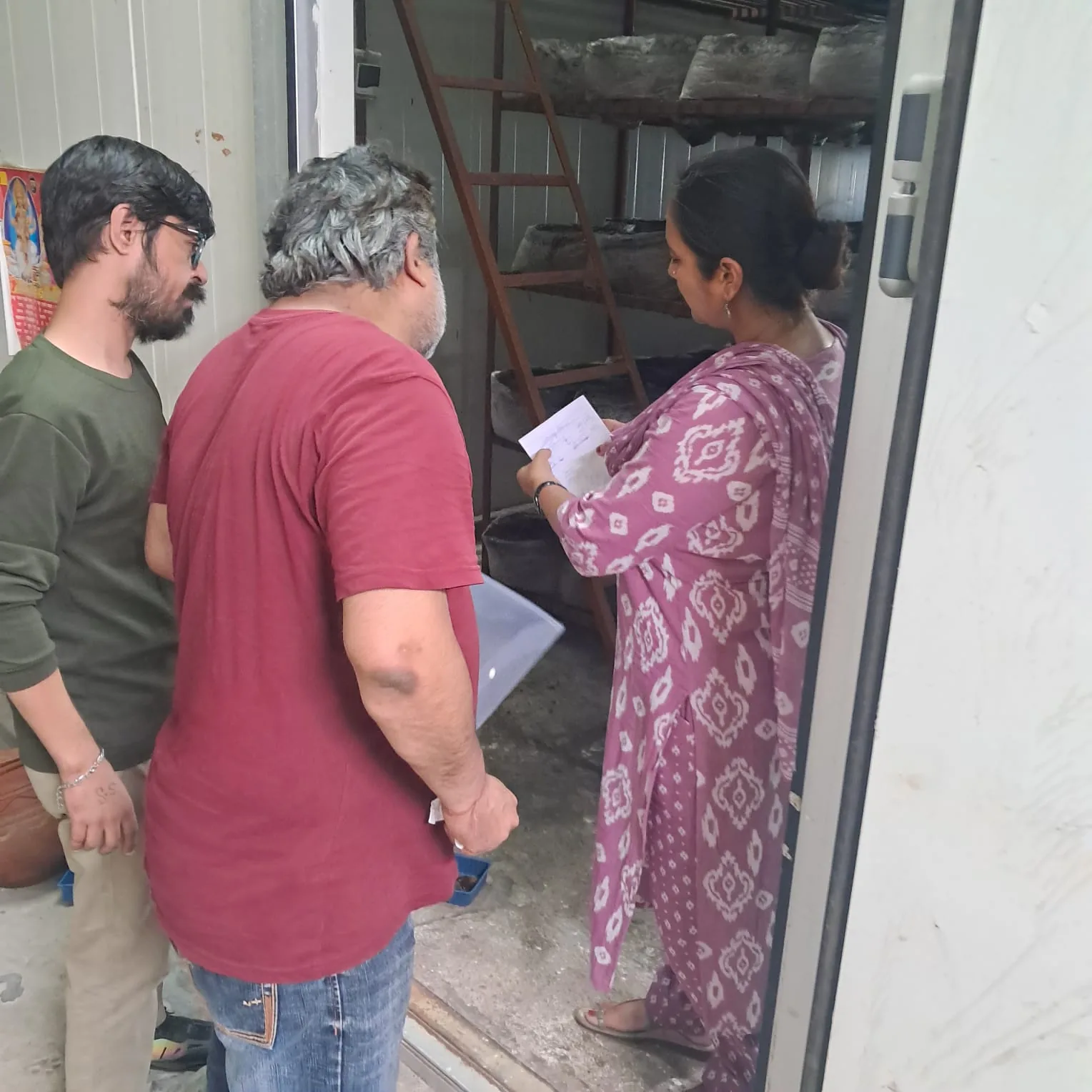Trainees observing mushroom cultivation setup during a farm visit