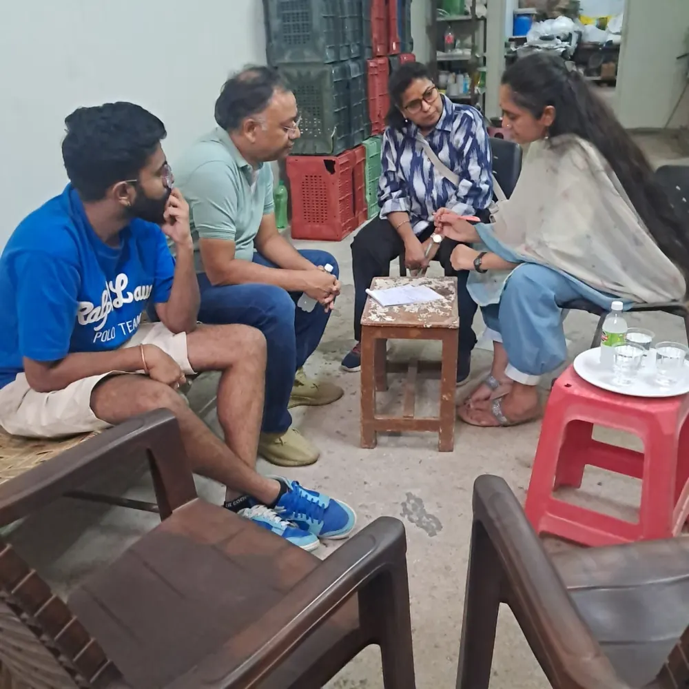 Trainees having a discussion on chairs during a farm visit