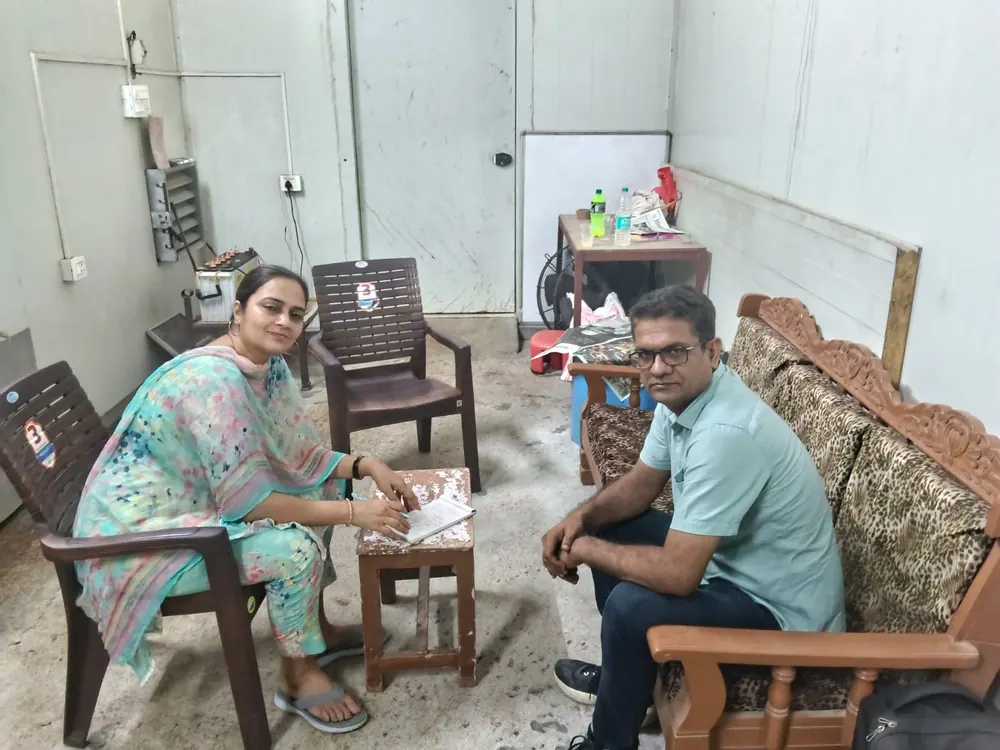 Dr. Sonia Dahiya taking notes during a one-on-one consultation with a visiting farmer at the Sonipat farm