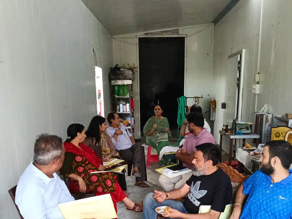 Seated question and answer session with handouts and tea at the farm